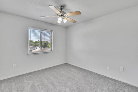 Apartment Bedroom with Window and Ceiling Fan